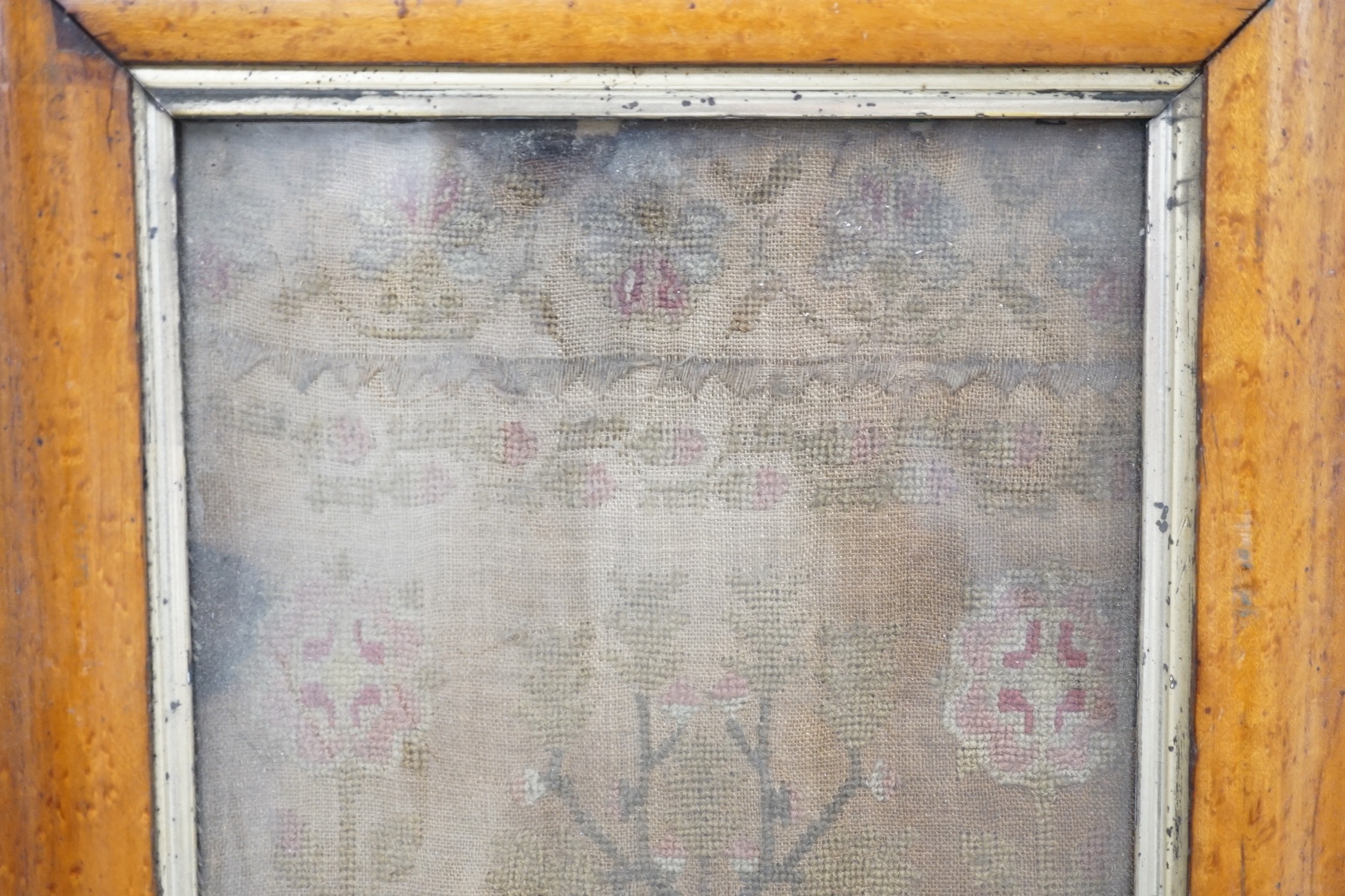 A George III needlework sampler in later maple frame, 42 x 18cm